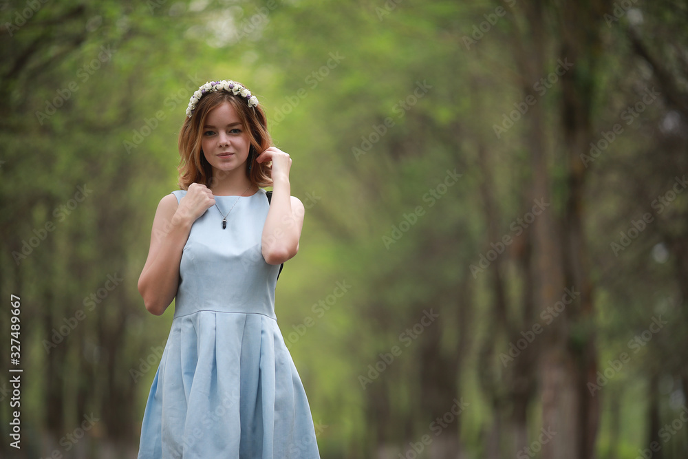 Girl in blue dress in green park Girl in blue dress in green park