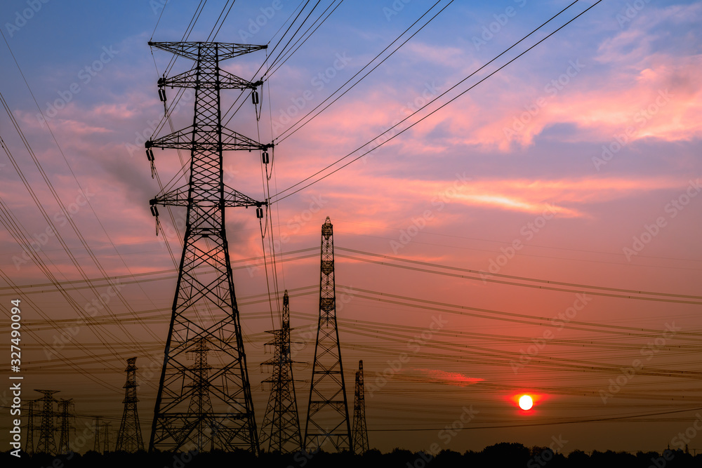 Fototapeta premium High voltage power tower and beautiful nature landscape at sunset