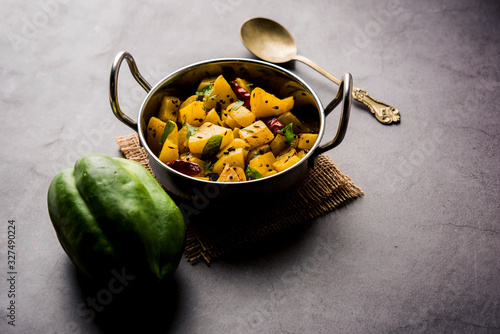 Kaccha Papita Sabji or Raw Papaya Sabzi, served in a karahi or bowl. selective focus photo