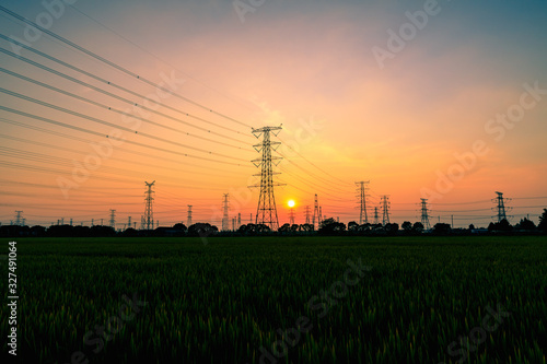 High voltage power tower and beautiful nature landscape at sunset