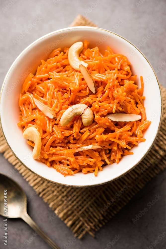 Vermicelli / Semiya Kesari is a popular indian sweet served in a bowl, garnished with dry fruits like cashew and almond, made in pure ghee Vermicelli / Semiya Kesari is a popular indian sweet served in a bowl, garnished with dry fruits like cashew and almond, made in pure ghee