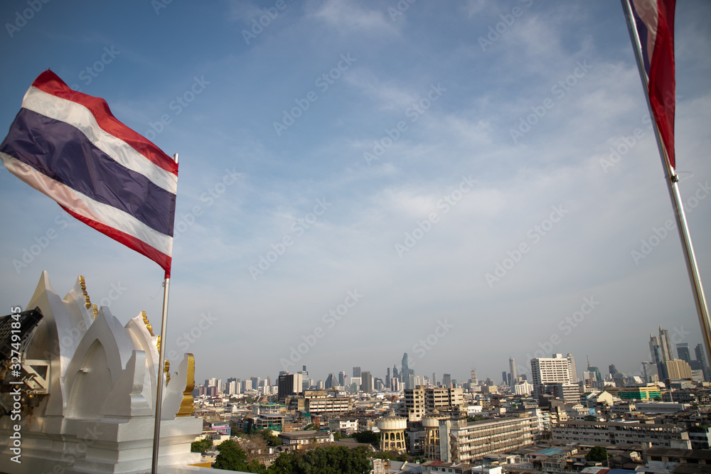 thai flag and Bangkok cityscape from Wat Saket Ratcha Wora Maha Wihan (Wat Phu Khao Thong, Golden Mount temple), a popular Bangkok tourist attraction, Thailand