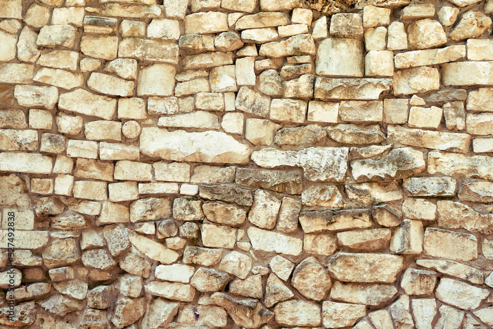 Background of retro stone wall, masonry texture of large cobblestones