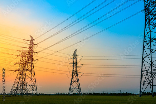 High voltage power tower and beautiful nature landscape at sunset