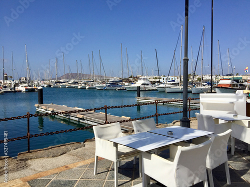 empty table of a restaurant with harbor view in Lanzarote, Playa Blanca © travelview