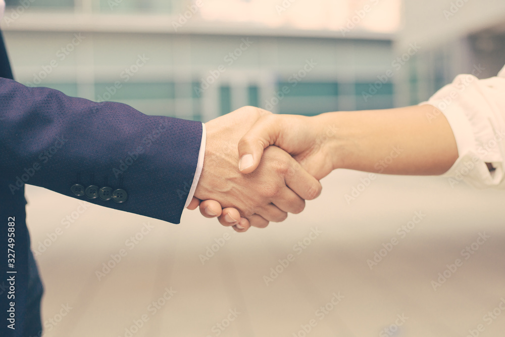 Fototapeta premium Closeup shot of business handshake. Cropped shot of two people wearing formal suits shaking hands. Business handshake concept