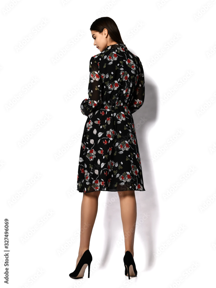 Young beautiful woman posing in new fashion casual trendy long dress walking backside view on white Young beautiful woman posing in new fashion casual trendy long dress walking backside view on white