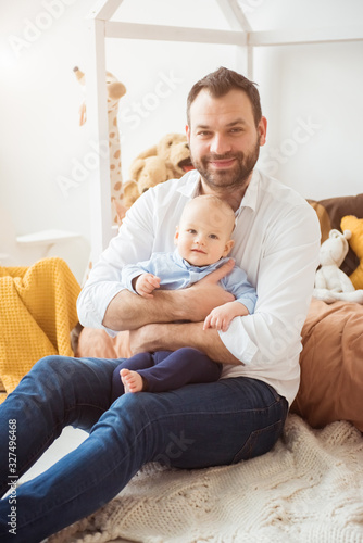 Happy father holding little baby son. Fatherhood concept © irena_geo