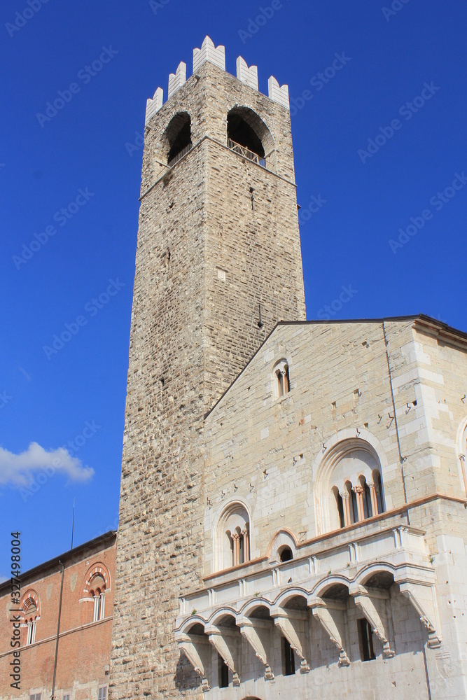 Facades of old town hall Broletto, tower Torre del Pegol, medieval house Loggia delle Grida on square Piazza Paolo VI in Brescia city, Lombardy, Italy.