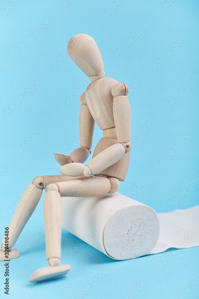 Puppet figures sitting on toilet paper with their stomachs covered Puppet figures sitting on toilet paper with their stomachs covered