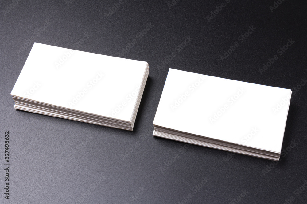 white blank business cards isolated on black background. close-up white blank business cards isolated on black background. close-up