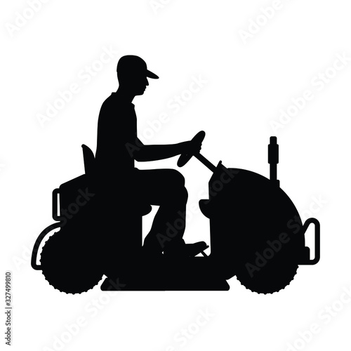 Man and grass mowing equipment silhouette