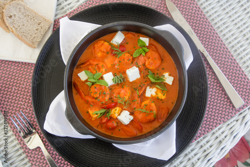 Shrimp with spicy tomato sauce, feta cheese and herbs	