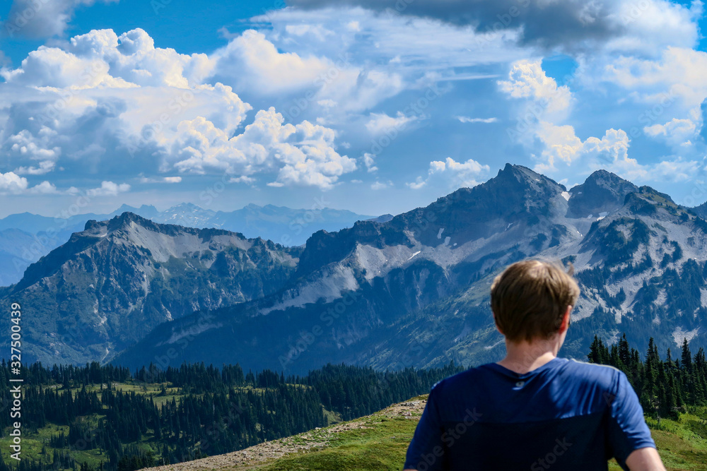 Man watches mountains and clouds