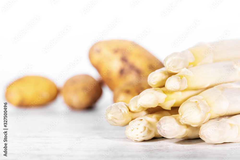 lot of fresh brown potatoes and white asparagus lot of fresh brown potatoes and white asparagus