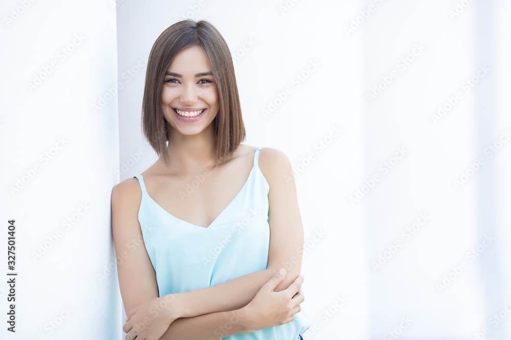 Attractive young brunette woman outdoors. Urban lady. Cheerful female on neutral background. Attractive young brunette woman outdoors. Urban lady. Cheerful female on neutral background.