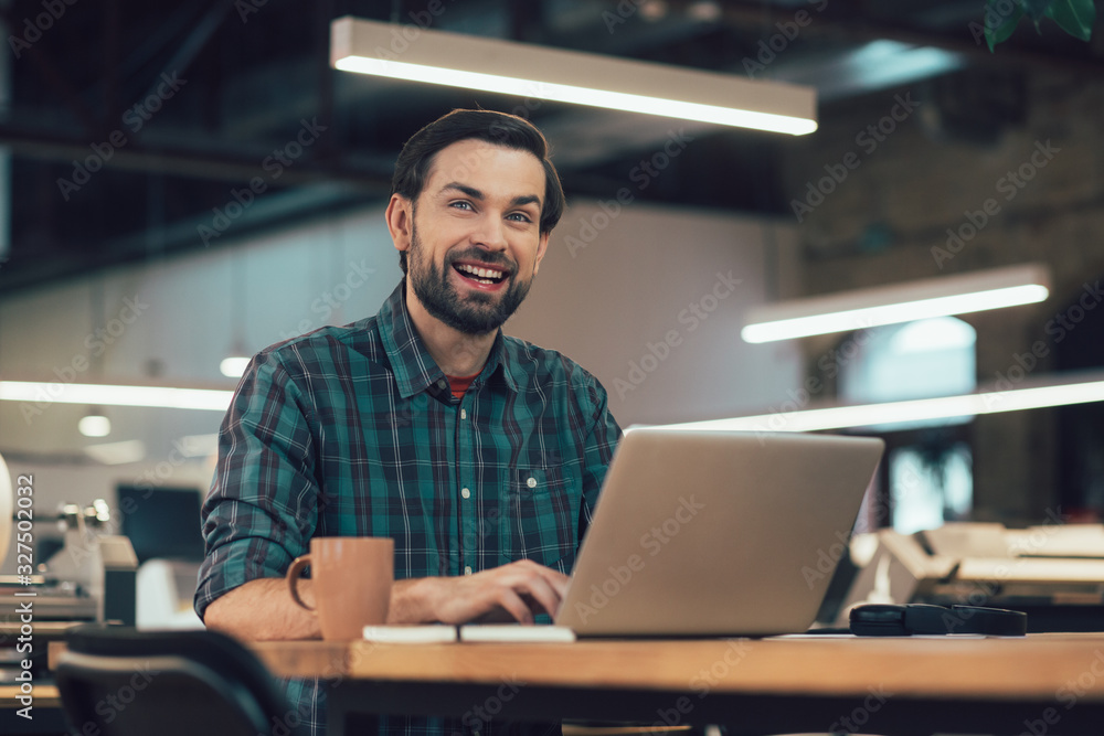Mirthful office worker with laptop stock photo Mirthful office worker with laptop stock photo