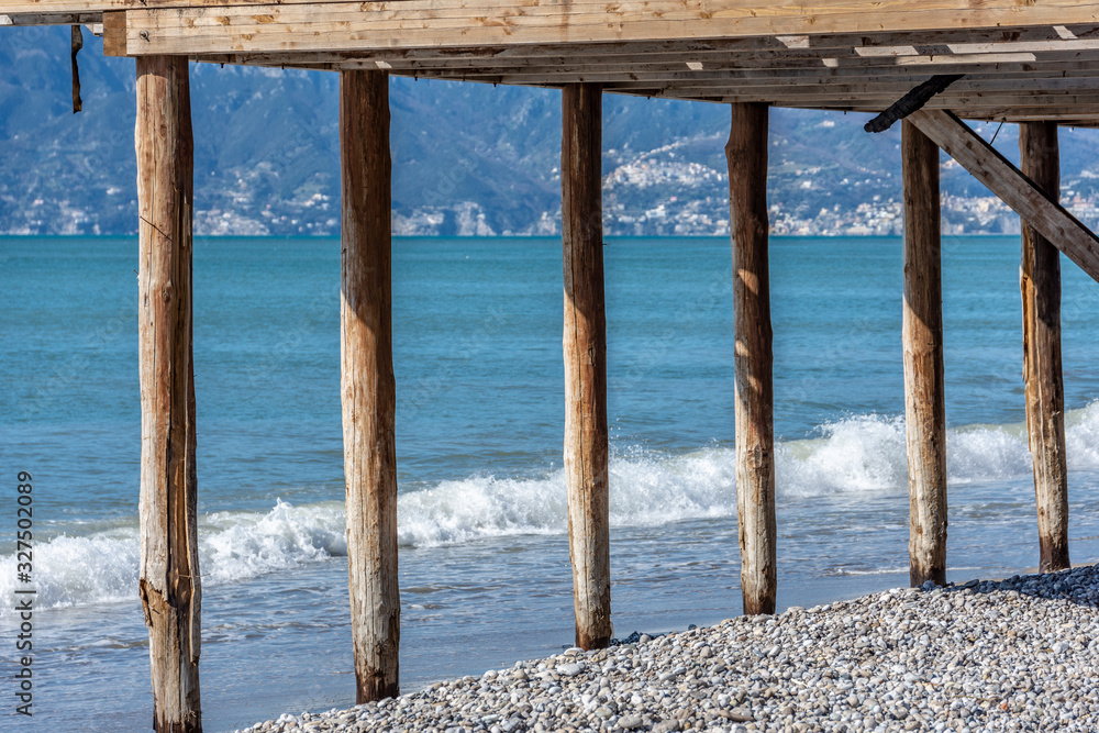Structure with wooden pillars on the beach