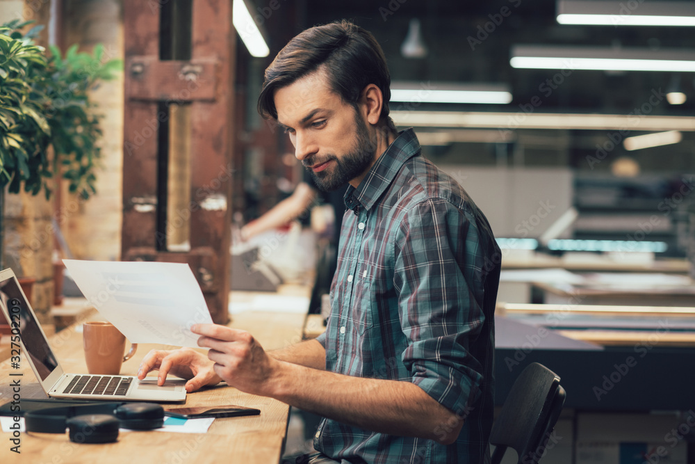 Attentive man working with documents stock photo Attentive man working with documents stock photo