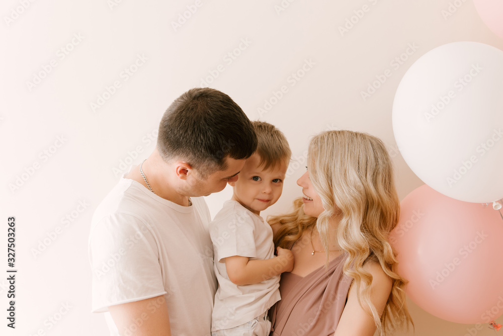 Schastlivaya smiling dogs are a young family with a child with balloons on light background Schastlivaya smiling dogs are a young family with a child with balloons on light background