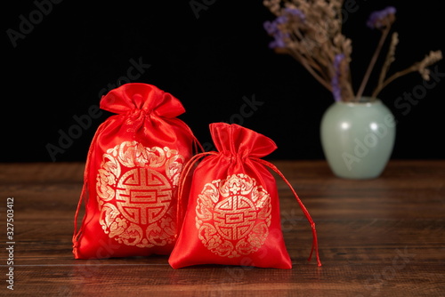 The traditional Chinese Red sachet is embroidered with a blessing pattern, indicating peace and blessing