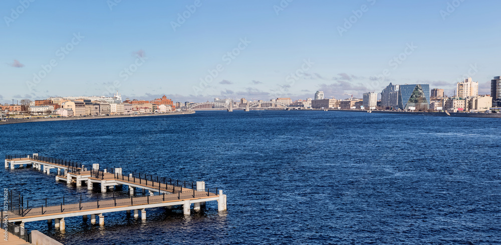 Panorama of the Neva river with a view of the Peter the Great bridge in Saint Petersburg.