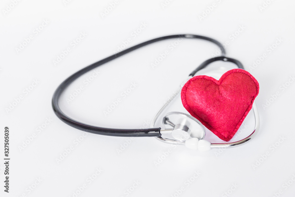 A heart with a stethoscope, isolated on white background A heart with a stethoscope, isolated on white background
