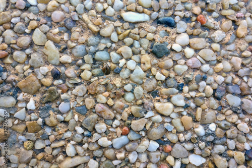Texture of small colored pebbles on the beach