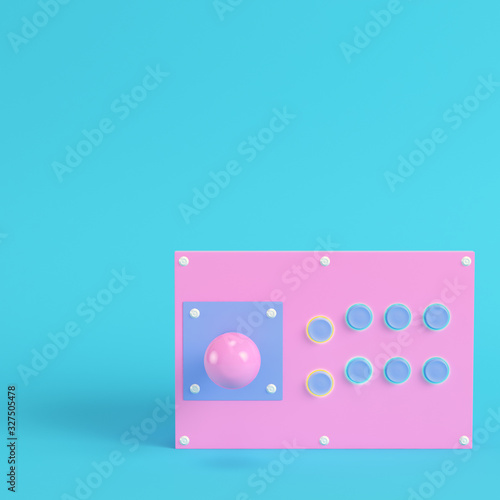 Retro arcade game controller on bright blue background in pastel colors