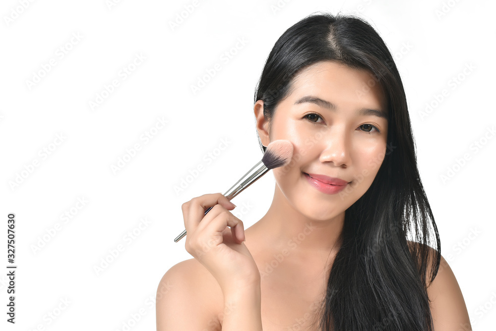Asian woman holding make up brush and poses for healthy skin beauty in white isolated background. Cosmetic, skincare, surgery concept with copy space. She is happy, fresh and youthful face. Asian woman holding make up brush and poses for healthy skin beauty in white isolated background. Cosmetic, skincare, surgery concept with copy space. She is happy, fresh and youthful face.
