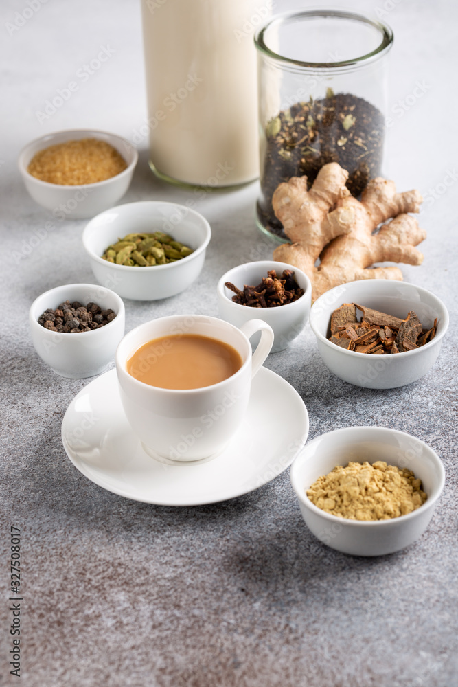 Cup of traditional indian masala chai. Ingredients for spicy milk tea on concrete background. Cup of traditional indian masala chai. Ingredients for spicy milk tea on concrete background.
