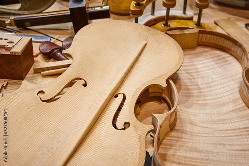 Luthier workshop with violin parts and tools. Traditional craftmanship. photo