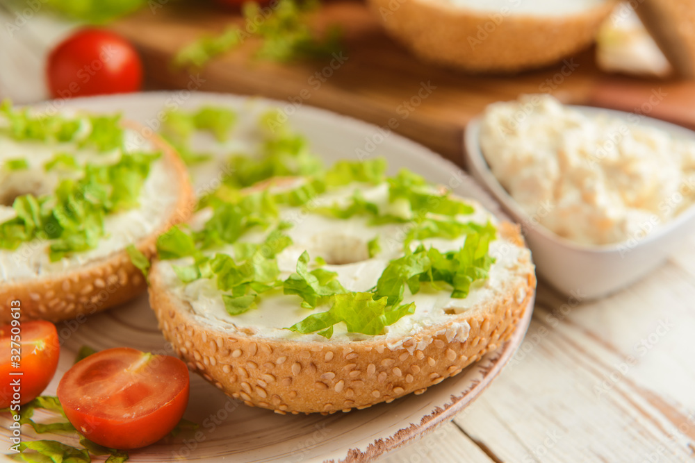 Fresh bun with tasty cream cheese and vegetables on plate Fresh bun with tasty cream cheese and vegetables on plate