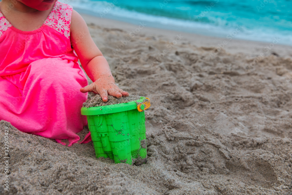 little girl playing with sand on beach vacation little girl playing with sand on beach vacation