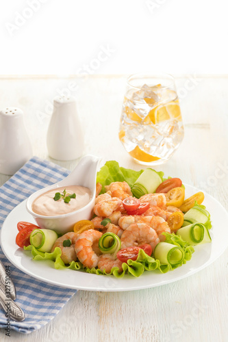 Grilled shrimp salad with fresh lettuce, cherry tomatoes and creamy sauce.