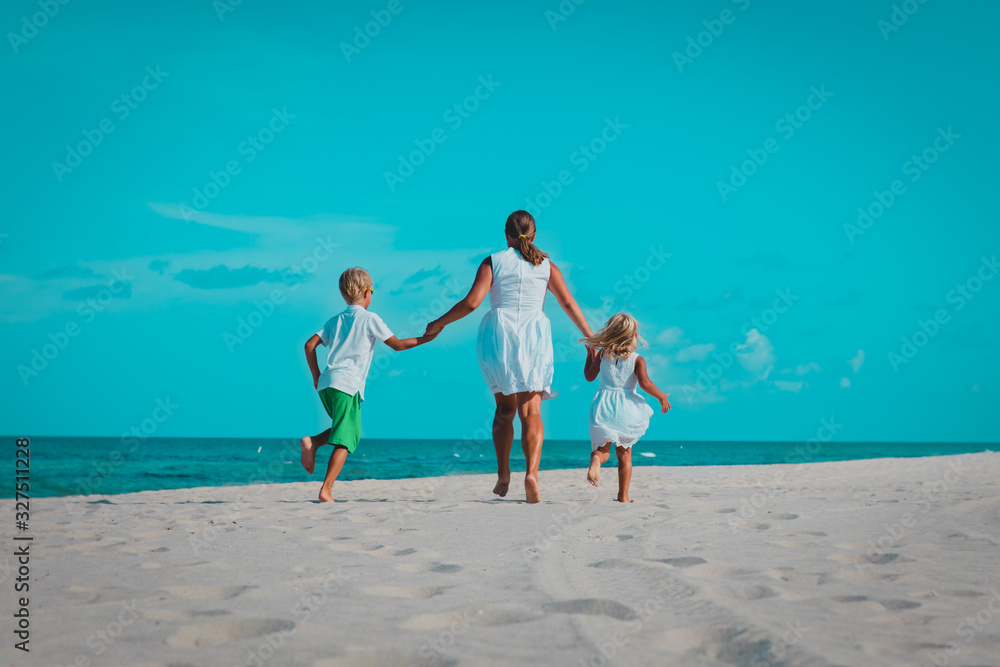 mother with kids play, family run on tropical beach