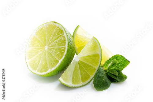 Fresh lime. Slices of ripe and juicy lime with green mint leaves close-up