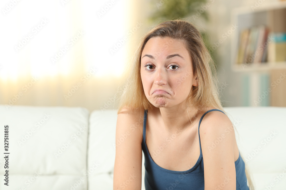 Hesitant teenage girl looking at camera Hesitant teenage girl looking at camera