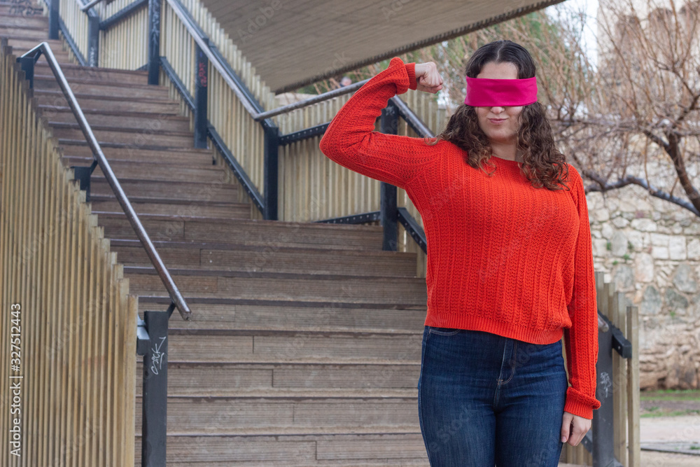 Portrait of rich attractive caucasian young woman with eye tape taking a lot of money dollars, in the park, orange sweater and jeans, long curly hair. Place for your text in copy space.
