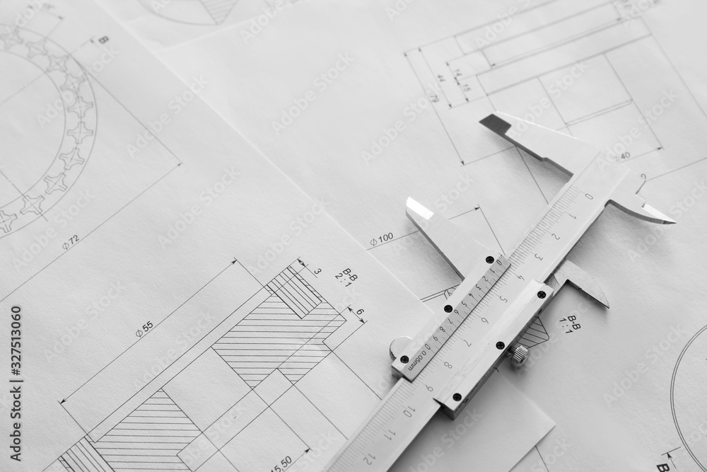 Vernier caliper and drawings on table of engineer Vernier caliper and drawings on table of engineer