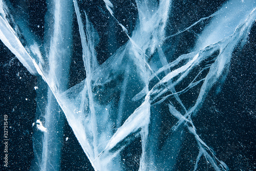 Methane Bubbles in the Baikal Ice.ice and cracks on the surface of Lake Baikal, Winter.Top view. Winter texture.Air bubbles in ice.Baikal ice. Crystal clear drinking water. 