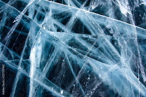 Methane Bubbles in the Baikal Ice.ice and cracks on the surface of Lake Baikal, Winter.Top view. Winter texture.Air bubbles in ice.Baikal ice. Crystal clear drinking water. 