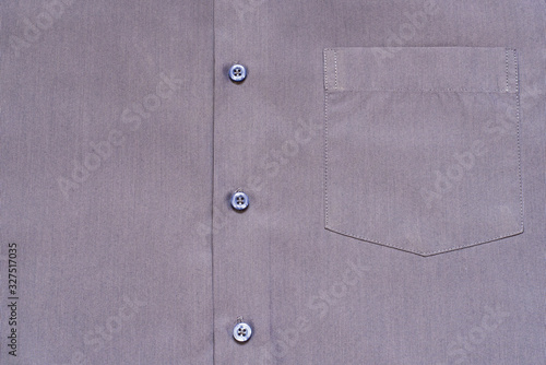 Fragment of a man?s shirt with a pocket and buttons