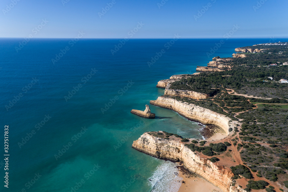 Aerial drone photo of the beautiful coastline along Porches and the beaches, near Armacao de Pera, Algarve, Portugal