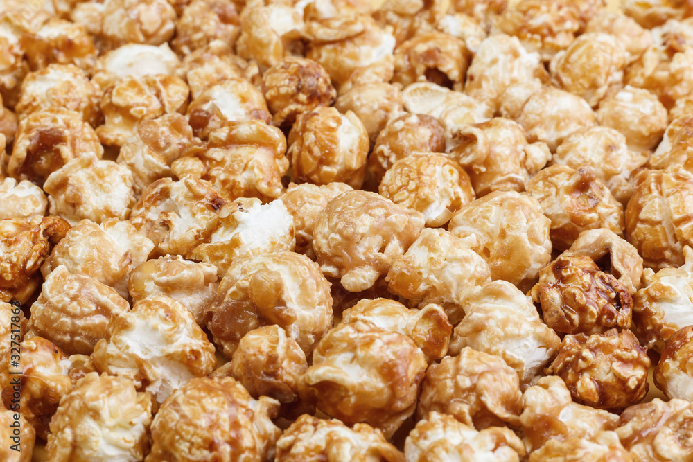 Heap of delicious caramel popcorn, isolated on white background . Scattered popcorn texture background. Heap of delicious caramel popcorn, isolated on white background . Scattered popcorn texture background.