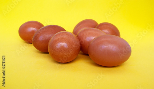 natural diet Easter eggs in orange color lie on a yellow background