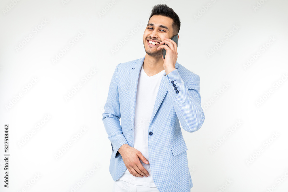 stylish man in a jacket talking on the phone on a white studio background stylish man in a jacket talking on the phone on a white studio background
