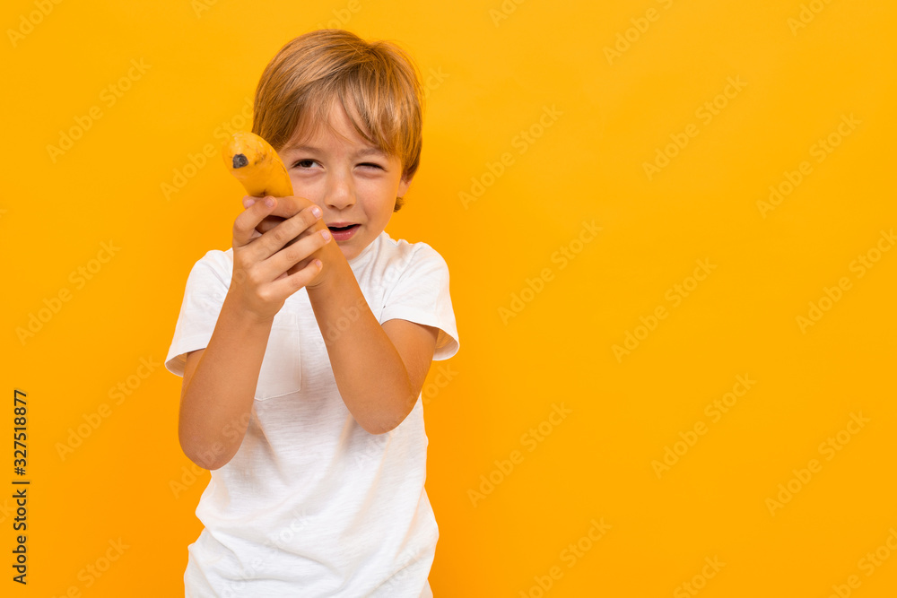 Cute little boy in t-shirt and trousers isolated on yellow background Cute little boy in t-shirt and trousers isolated on yellow background