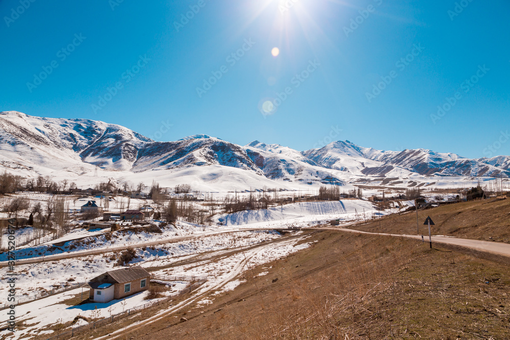 Mountains with melting snow. The end of winter, the beginning of spring. Kyrgyzstan