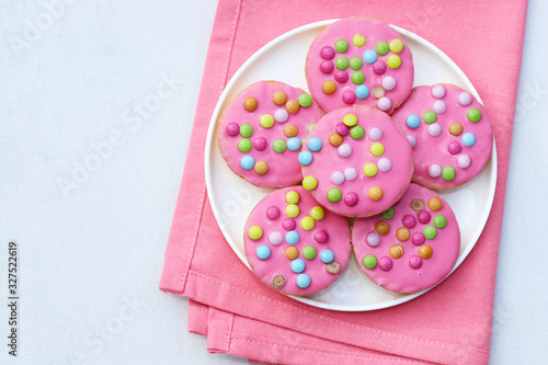Pink cookies with colorful smarties. © dorotaam